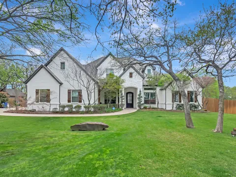 Large painted brick home on a mature Colleyville lot
