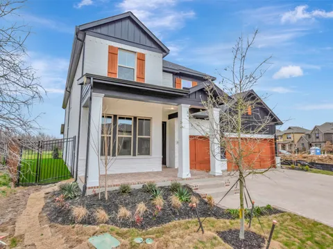 Coppell home with painted trim and a timber garage door