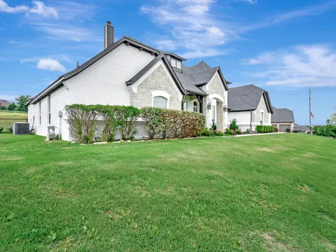 Two-story Flower Mound elevation in painted brick and stone