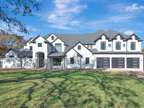Newer Frisco home with painted white brick and black window frames