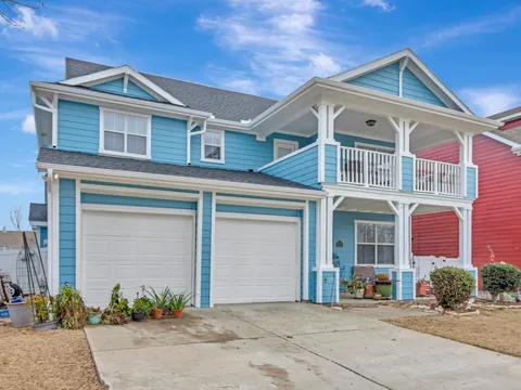 Two-story Grapevine home with painted siding and a covered porch
