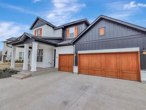 Two-story Roanoke home with painted trim and a timber garage door