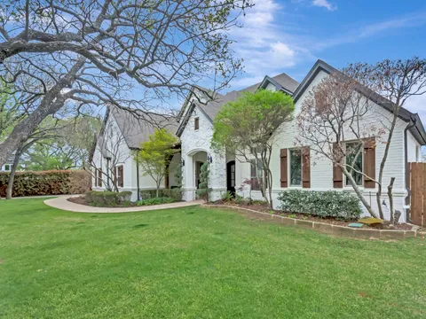 Painted brick University Park house behind mature planting