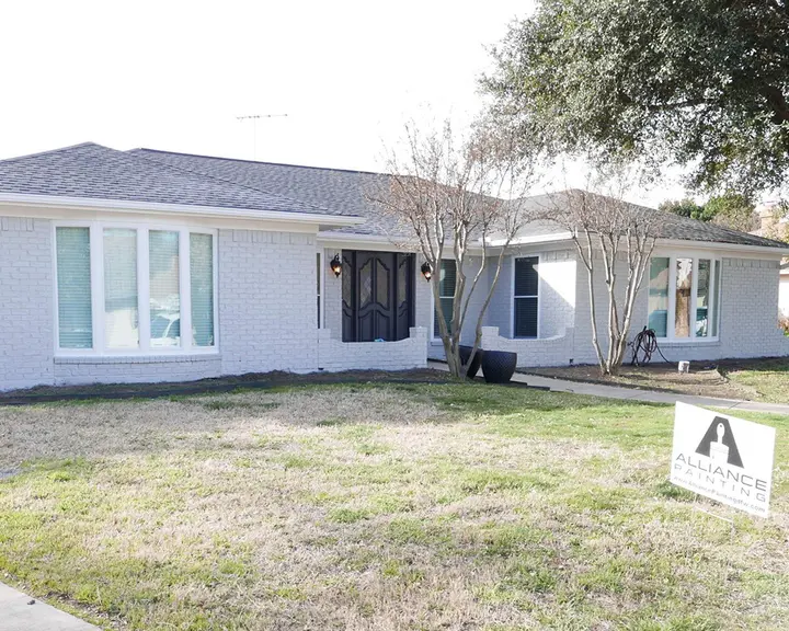 Red brick ranch finished in white mineral masonry paint — after
