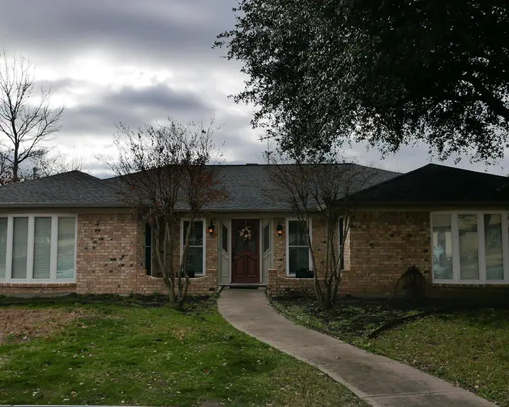 Red brick ranch finished in white mineral masonry paint — before