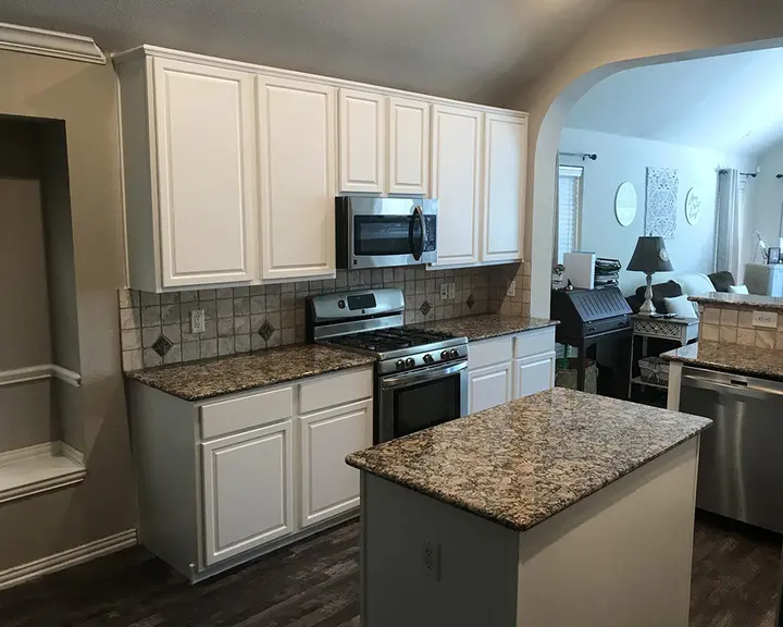 Oak kitchen cabinetry taken to a painted white finish — after
