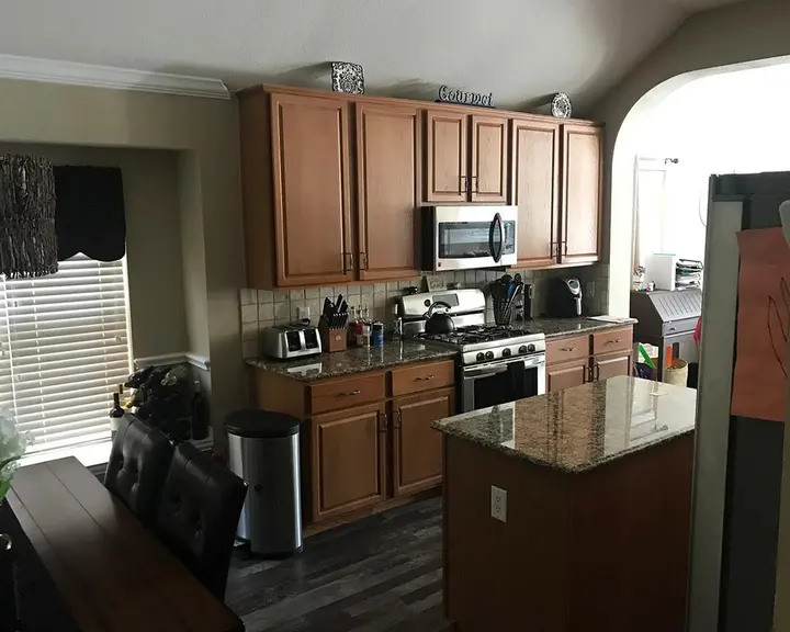 Oak kitchen cabinetry taken to a painted white finish — before
