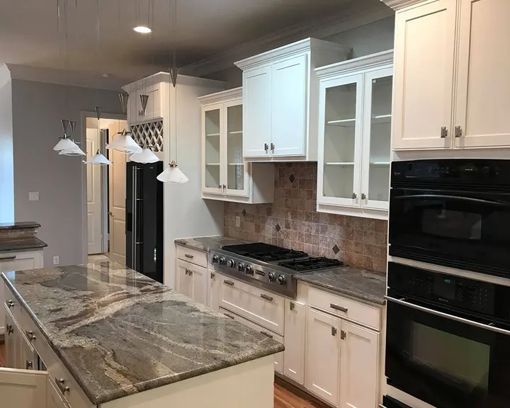 Cherry cabinets and island repainted, worktops kept — after