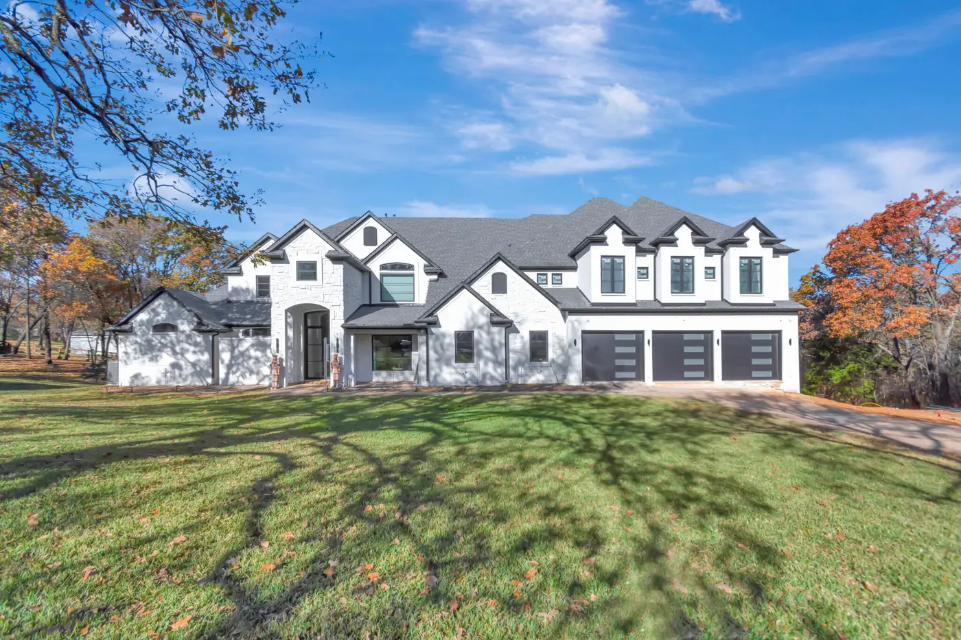 Painted white brick elevation with garage doors
