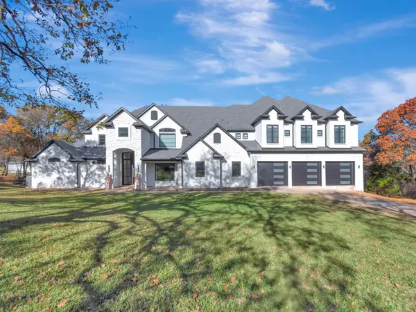 Painted white brick elevation with garage doors