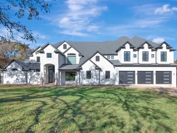 Painted white brick elevation with garage doors