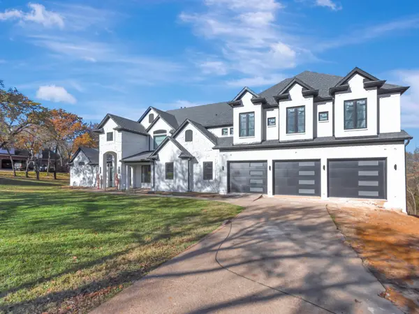 Painted white brick elevation with garage doors