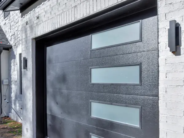 Painted white brick elevation with garage doors
