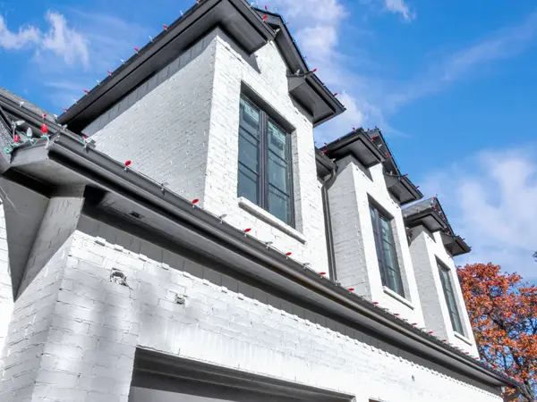 Painted white brick elevation with gables