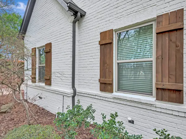 Painted brick elevation with timber shutters