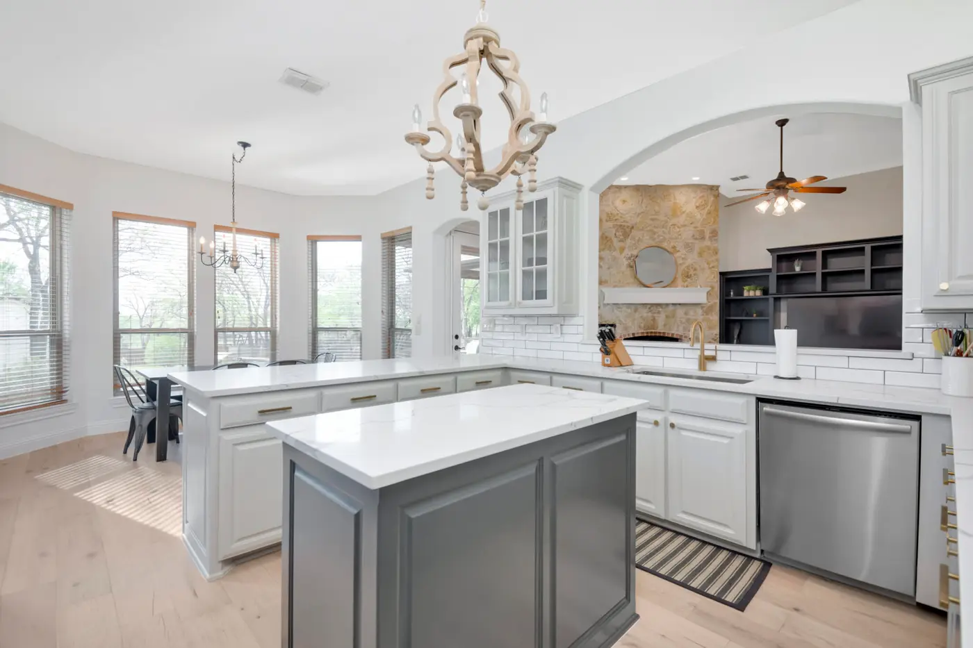 Painted kitchen cabinetry beneath an arched ceiling