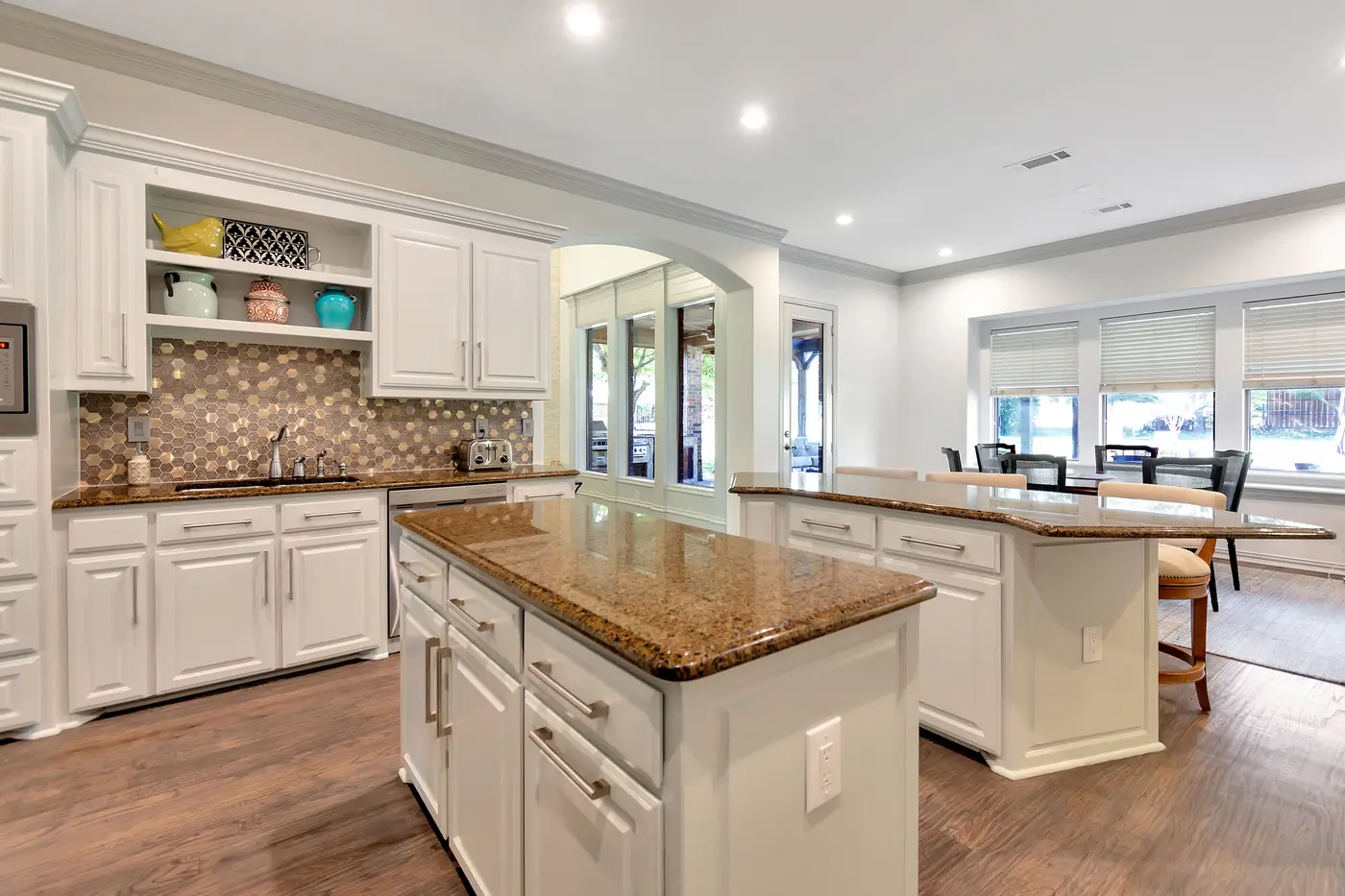 Painted kitchen cabinetry with granite worktops