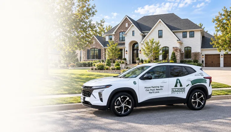 An Alliance Painting vehicle parked outside a large brick and stone home in Fort Worth