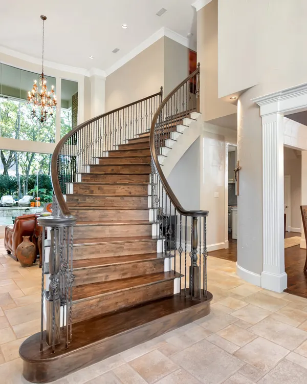 Curved staircase and freshly painted stair hall in a Dallas–Fort Worth home