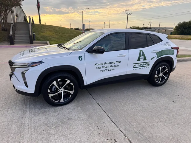 An Alliance Painting vehicle, signwritten with the company logo, parked at one of its offices at sunset