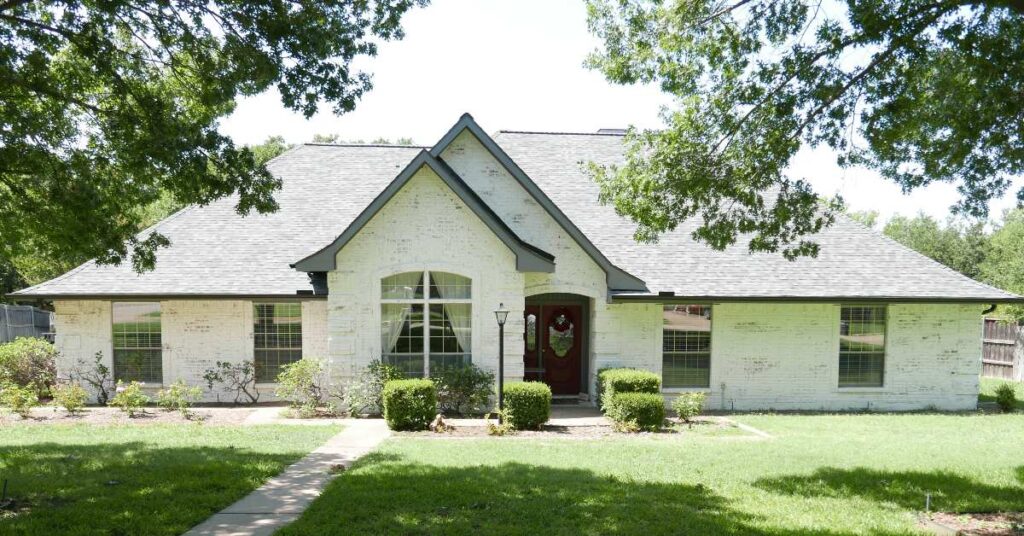 Image of the exterior of a beautiful limewashed brick home in the Dallas-Fort Worth Area